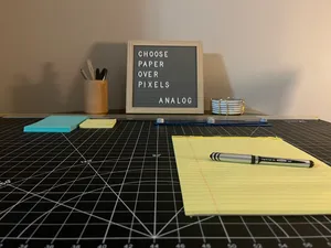 Letter Board with the phrase: Choose Paper Over Pixels